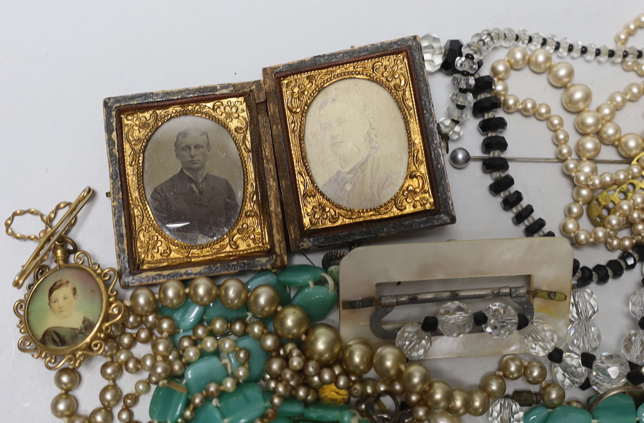 An early 20th century 9ct and gem set 'Suffragette' ring (stones missing) and a group of costume jewellery.